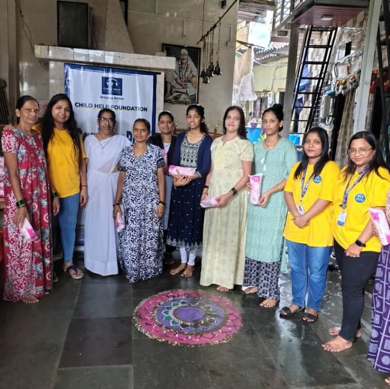 Child Help Foundation volunteers distributing sanitary pads to women in the community as part of their Menstrual Hygiene Management program