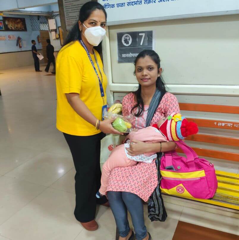 Child Help Foundation volunteer providing nutritional support to a nursing mother at a public hospital in India