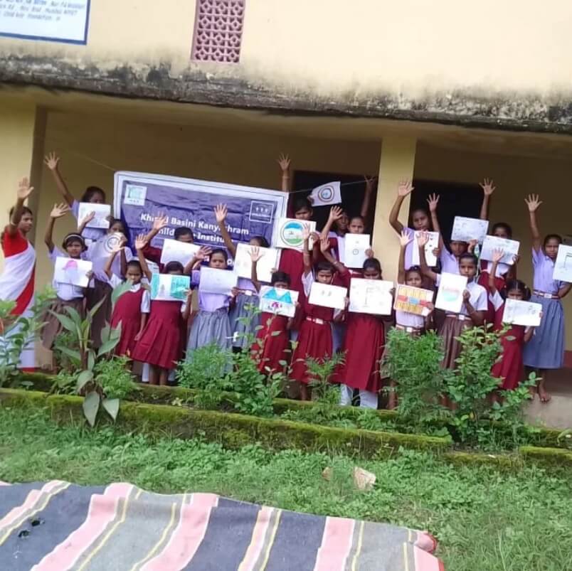Child Help Foundation gender awareness session with school girls holding up their drawings