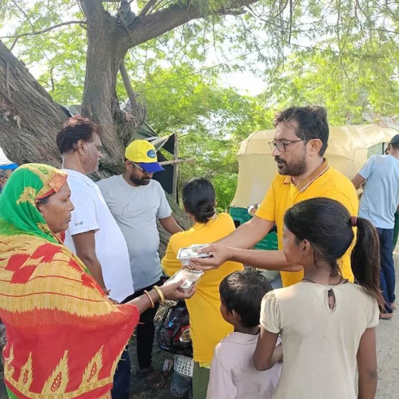 Child Help Foundation team distributing food packets to a family during relief work